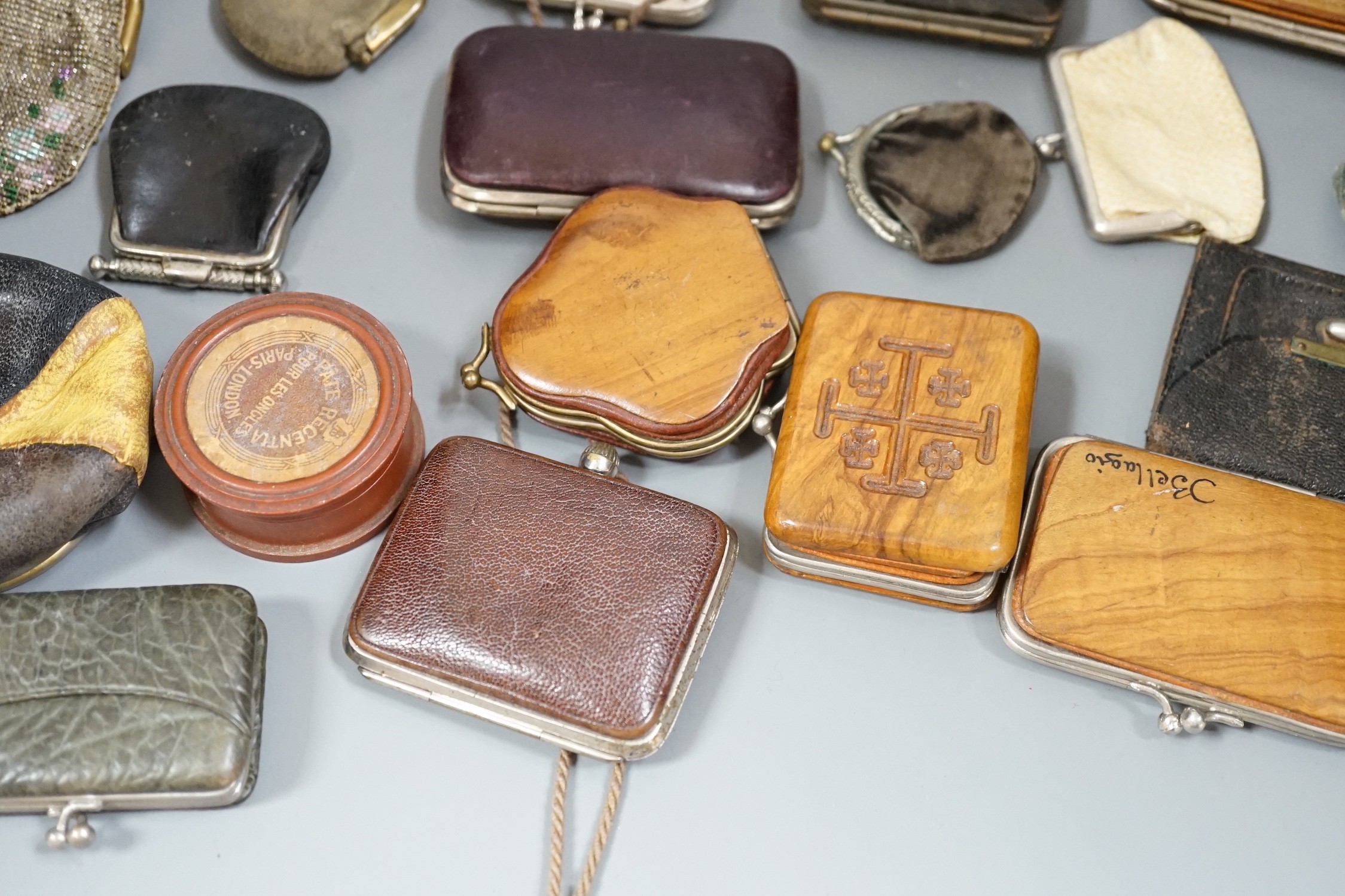 A collection of mostly Grand Tour, wooden souvenir purses and other 19th and 20th century leather and fur purses